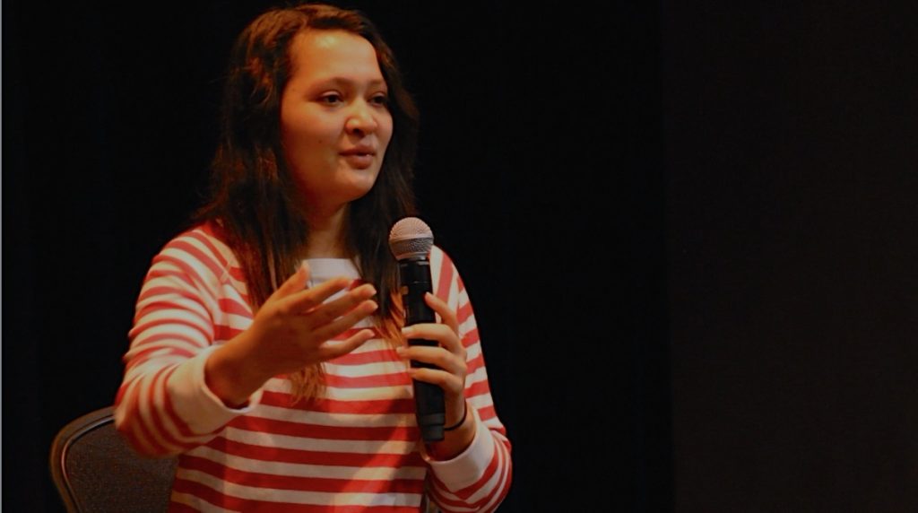 Sands of Silence character Lala speaking at New Roads High School